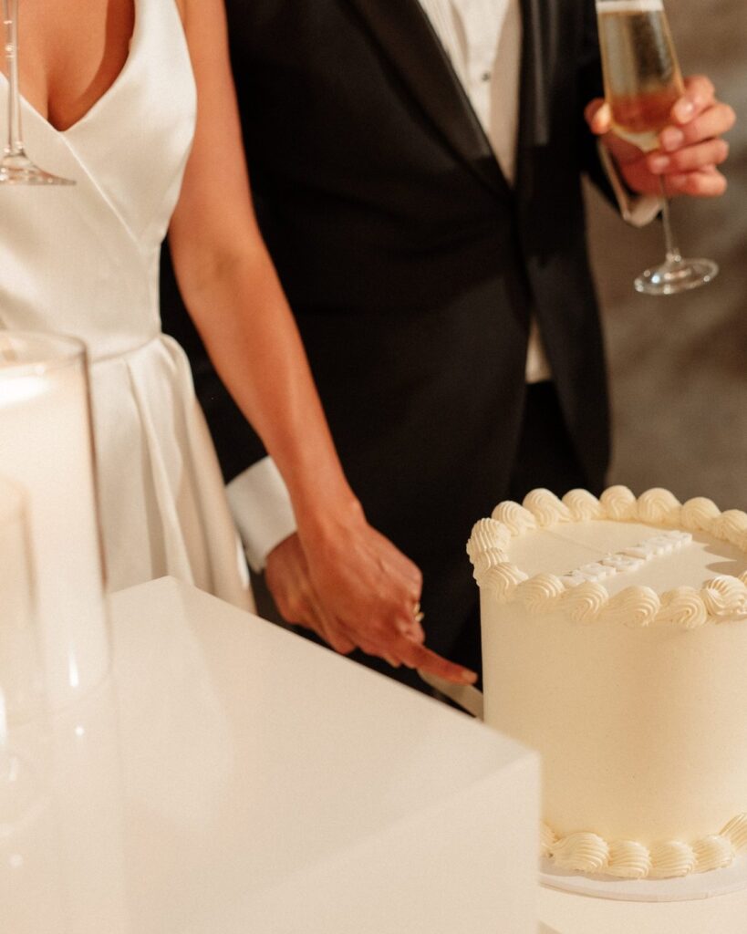 bride and groom cutting wedding cake