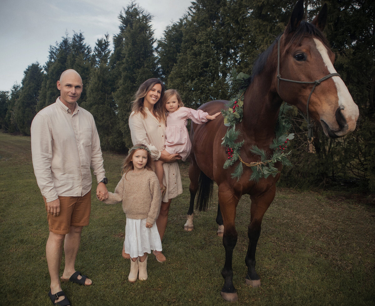 Family christmas portrait with a horse